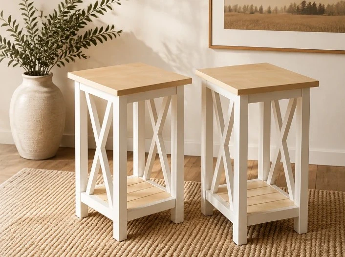 Two handcrafted light wood end tables with white bases in a warm interior